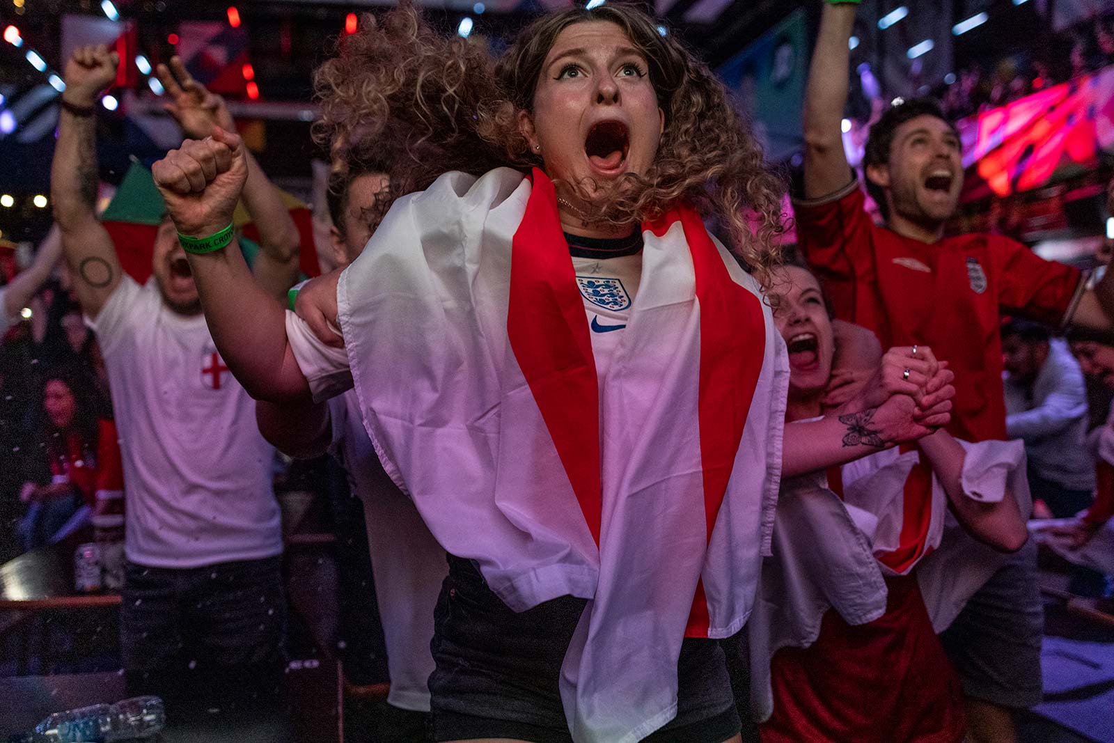 Excited England fan wrapped in a flag
